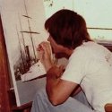 Ron Marlett working on a painting of a Coast Guard cutter.