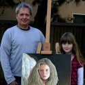 Ron Marlett and his grand niece next to his painting.